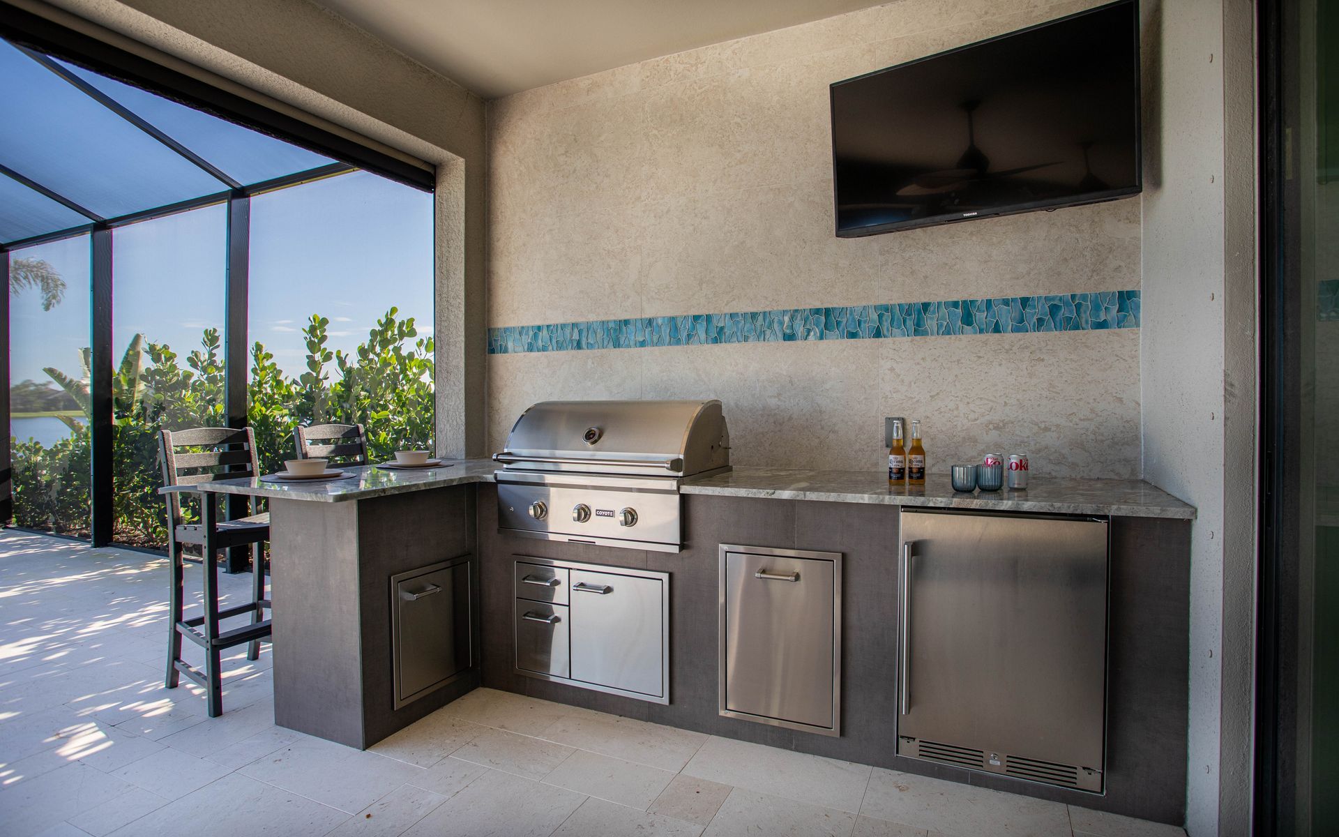 L Shape Outdoor Kitchen, Granite countertop, tile backsplash,Delta Heat Inserts, Zephyr fridge, Veranda Village FL