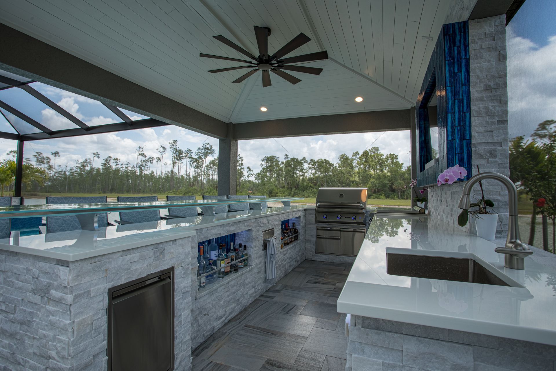 Large white stacked stone U shape outdoor kitchen, twin eagles grill, granite countertop , Custom TV build in, Naples FL