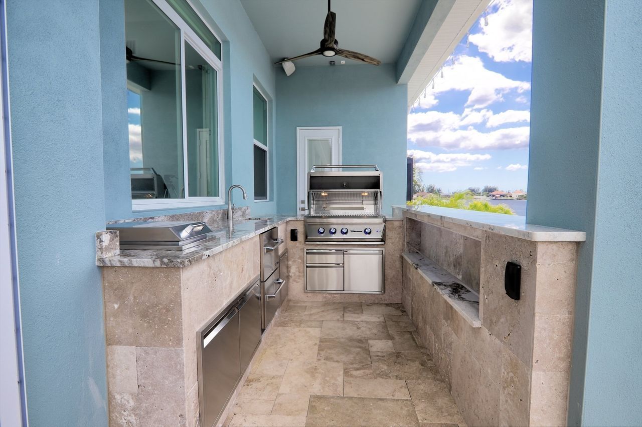 tan travertine tile outdoor kitchen, storage, grill, cape coral, fl