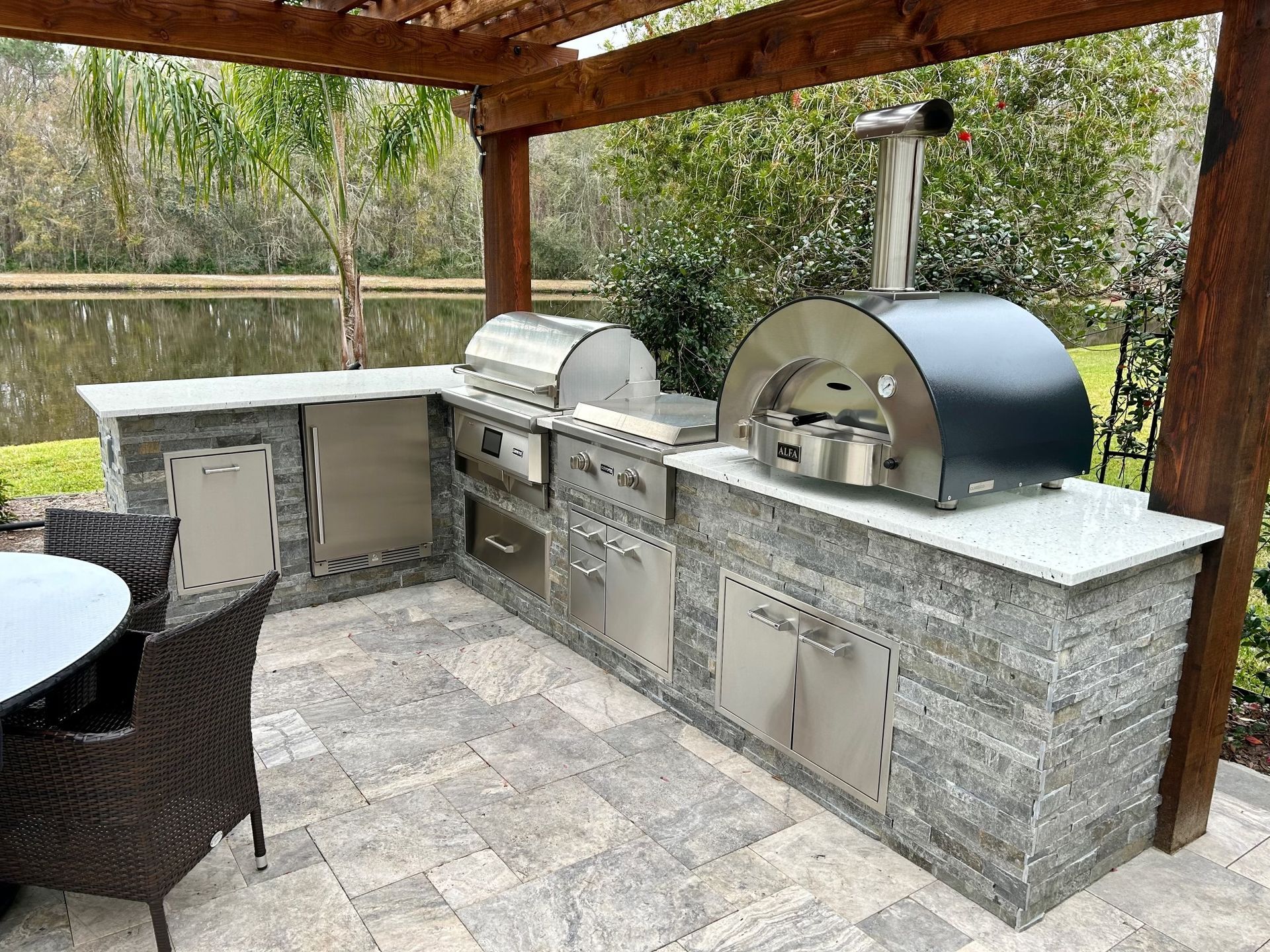 Freestanding L Shape Outdoor Kitchen under pergola, Granite countertop, Delta Heat Inserts, Pizza Fort Myers FL