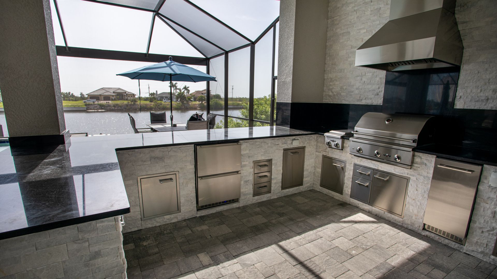 stacked stone U shape outdoor kitchen, twin eagles grill, stainless inserts, granite countertop, Marco Island FL