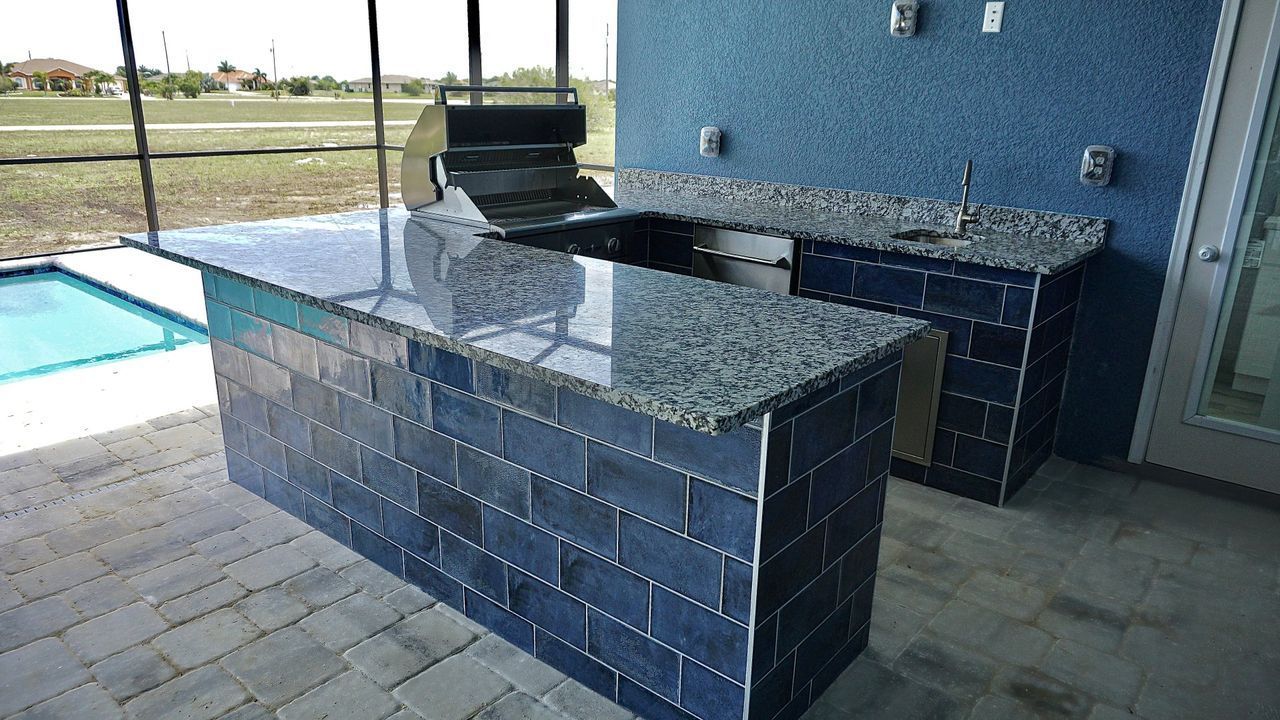 U shape outdoor kitchen, blue subway tile, grill, grnaite countertop, Estero FL
