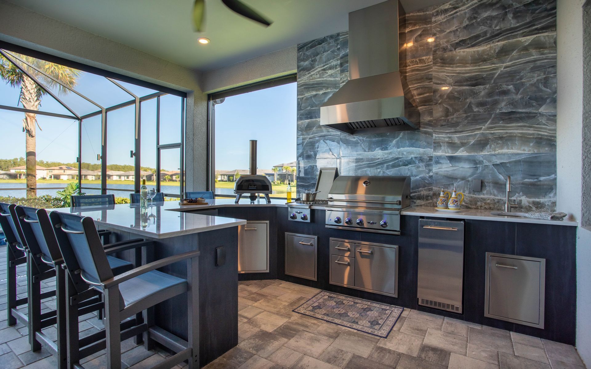 U shape outdoor kitchen, Black tile, pizza oven, stainless steel, Grill, sink, hood, modern, tile backsplash, Naples FL
