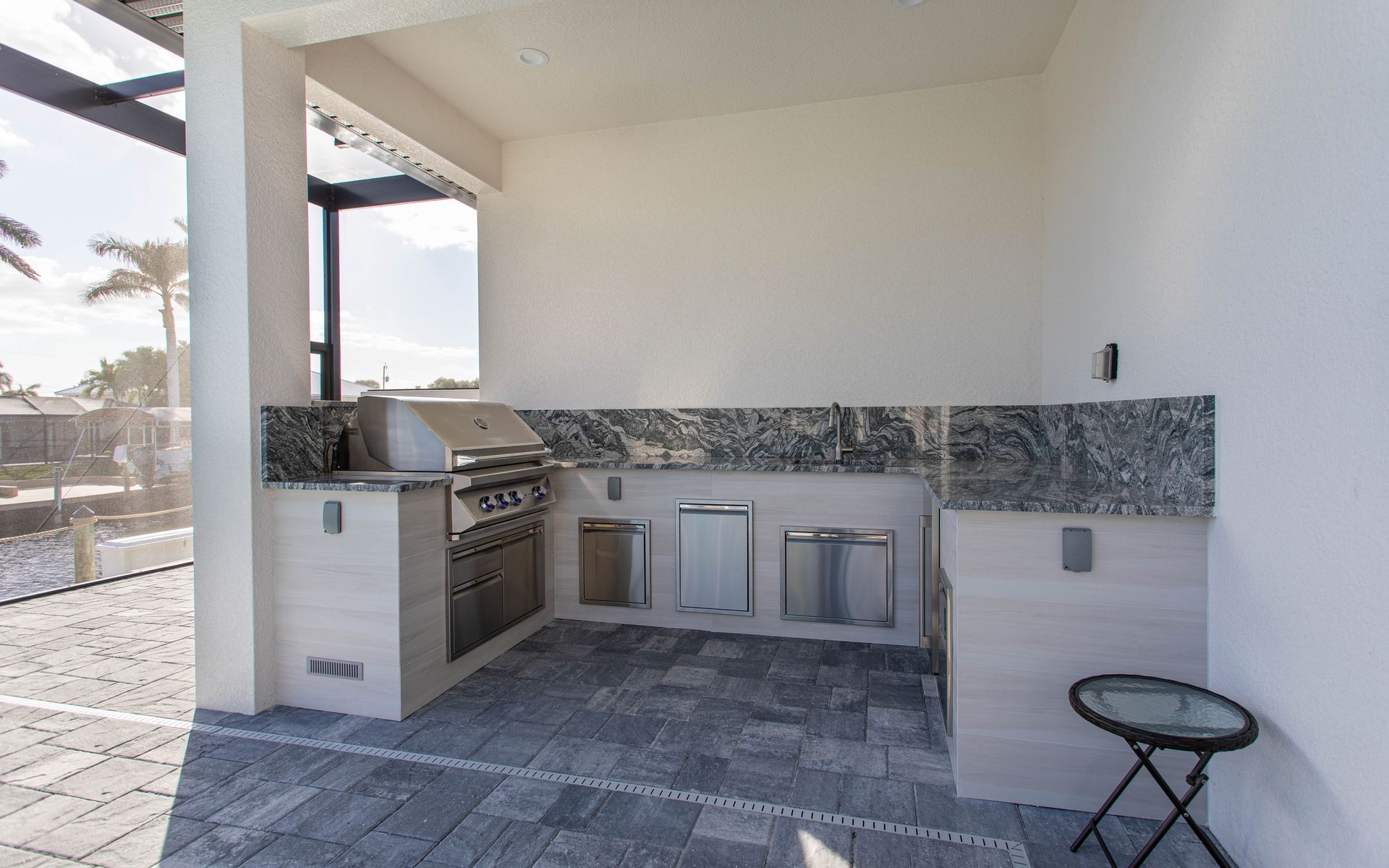 U Shape outdoor kitchen, wood look tile, grill ,storage, granite counter and backsplash, custom, sleek, Estero Fl