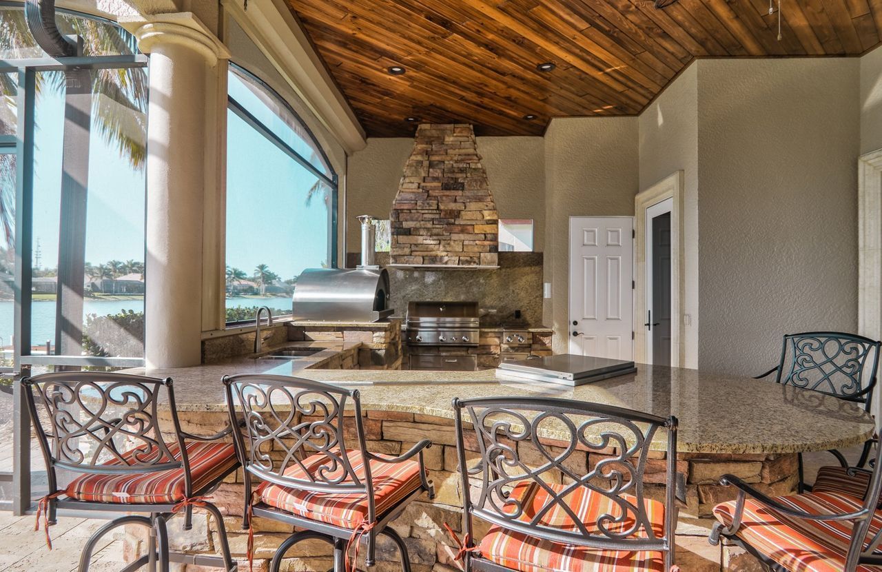 cultured stone outdoor kitchen cabinet finish and wood ceiling Miramar Lakes FL