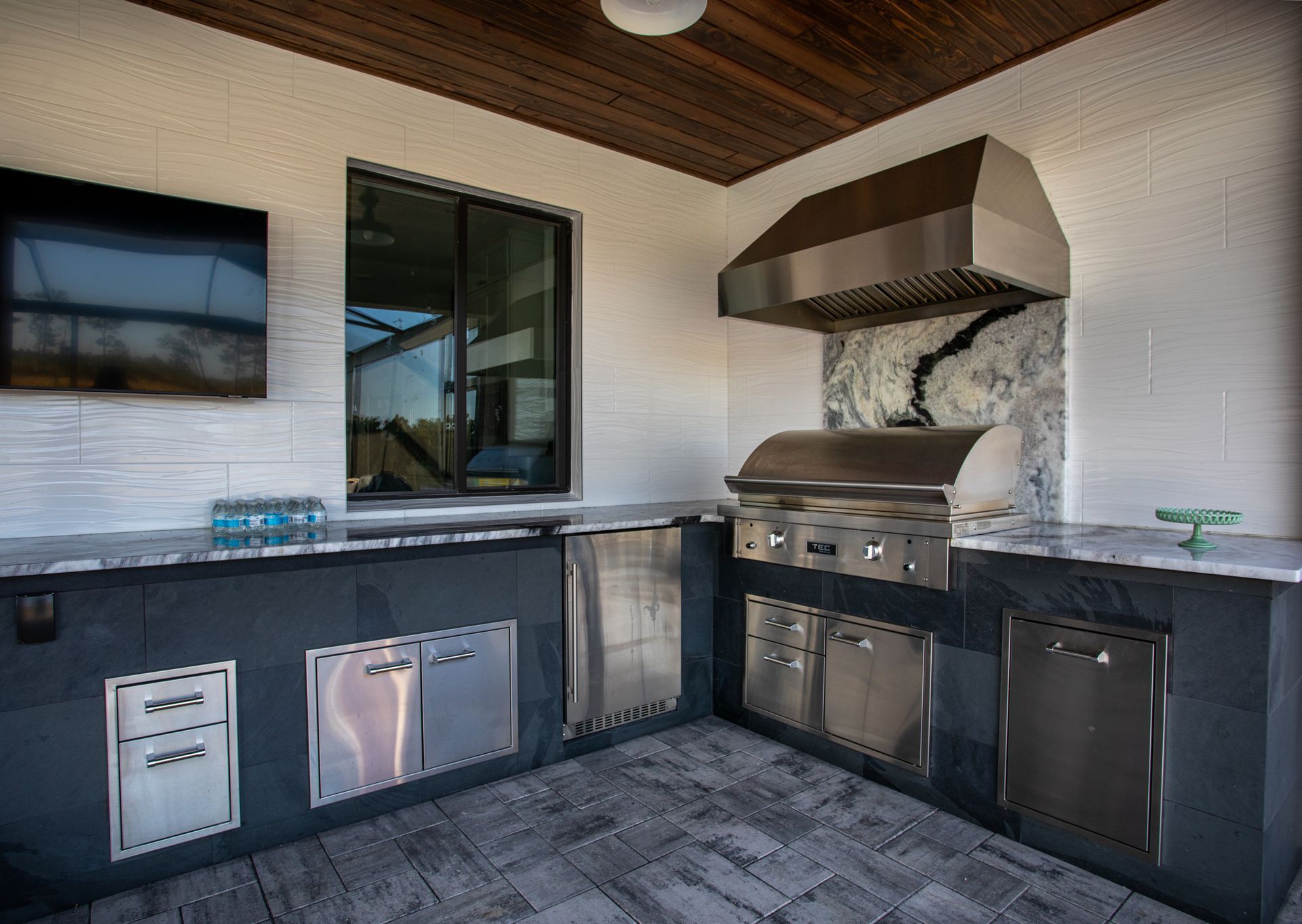 L Shape Outdoor Kitchen, Granite countertop, Twin Eagles Grill, Delta Heat Inserts, Fridge, Storage Port Charlotte
