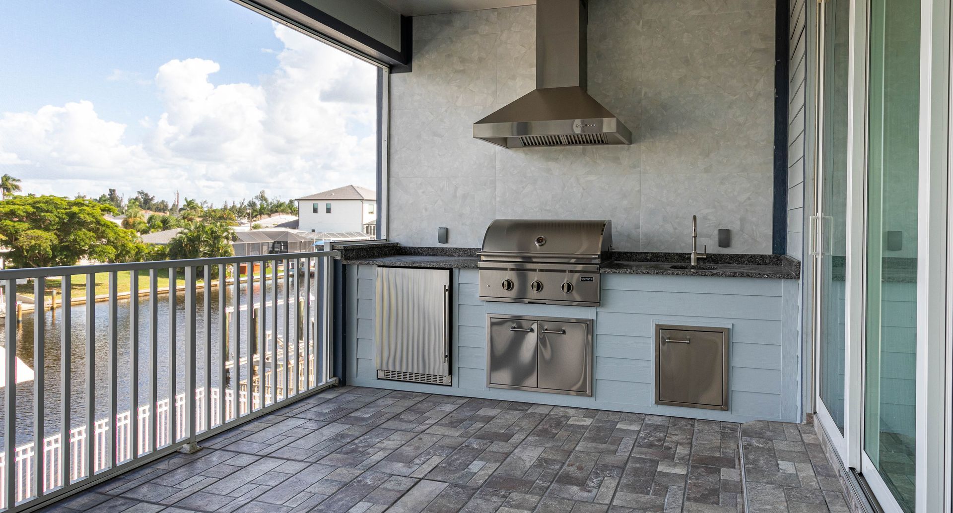 architectural outdoor kitchen lap siding sky blue with granite countertops