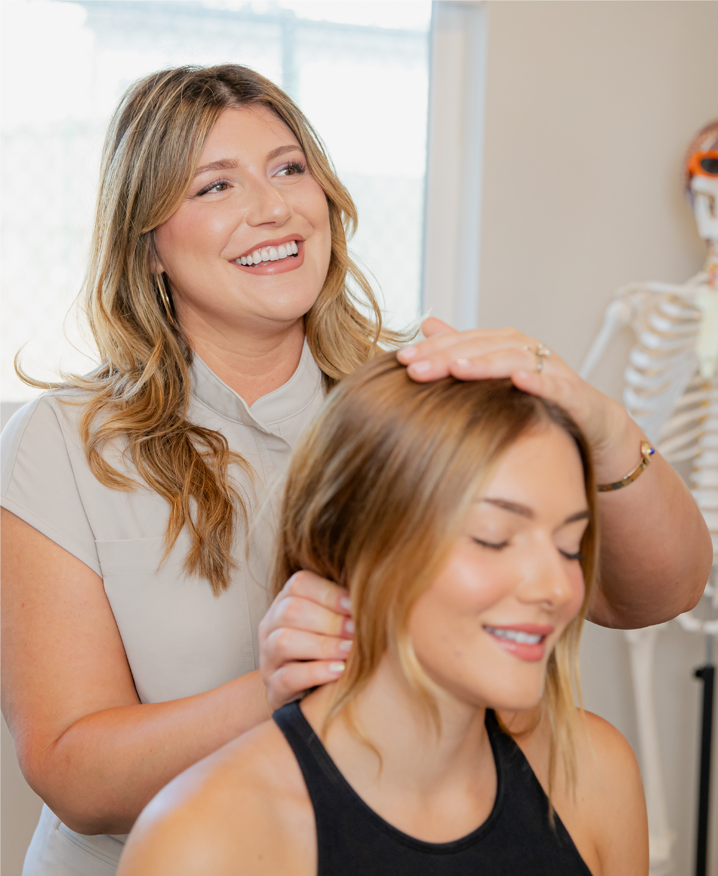 A woman is getting a lymphatic massage with her eyes closed.