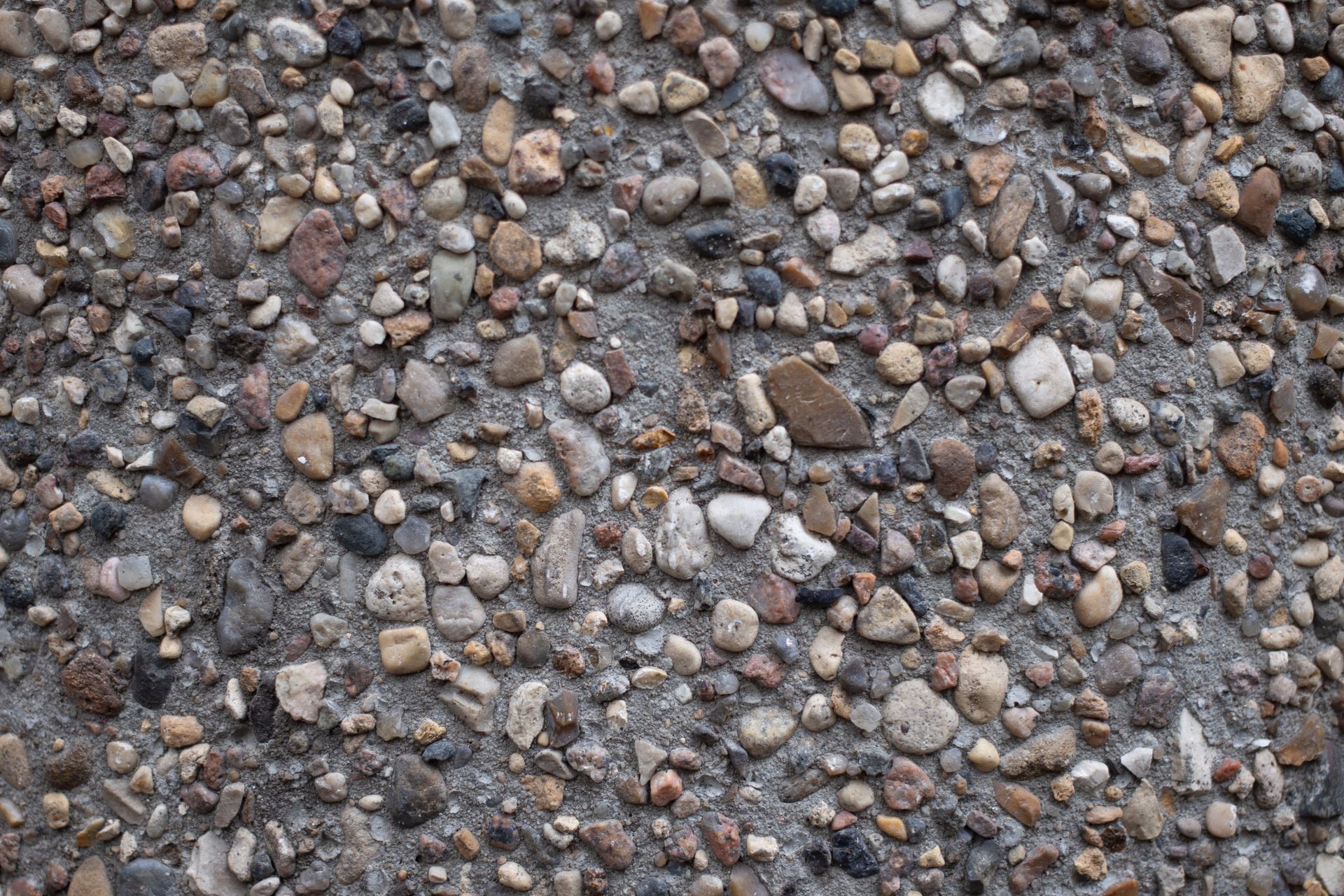 Close-up of small gray and brown pebbles covering the ground
