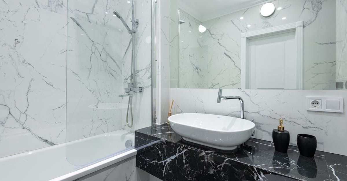 A bathroom with a sink , tub , mirror and shower.