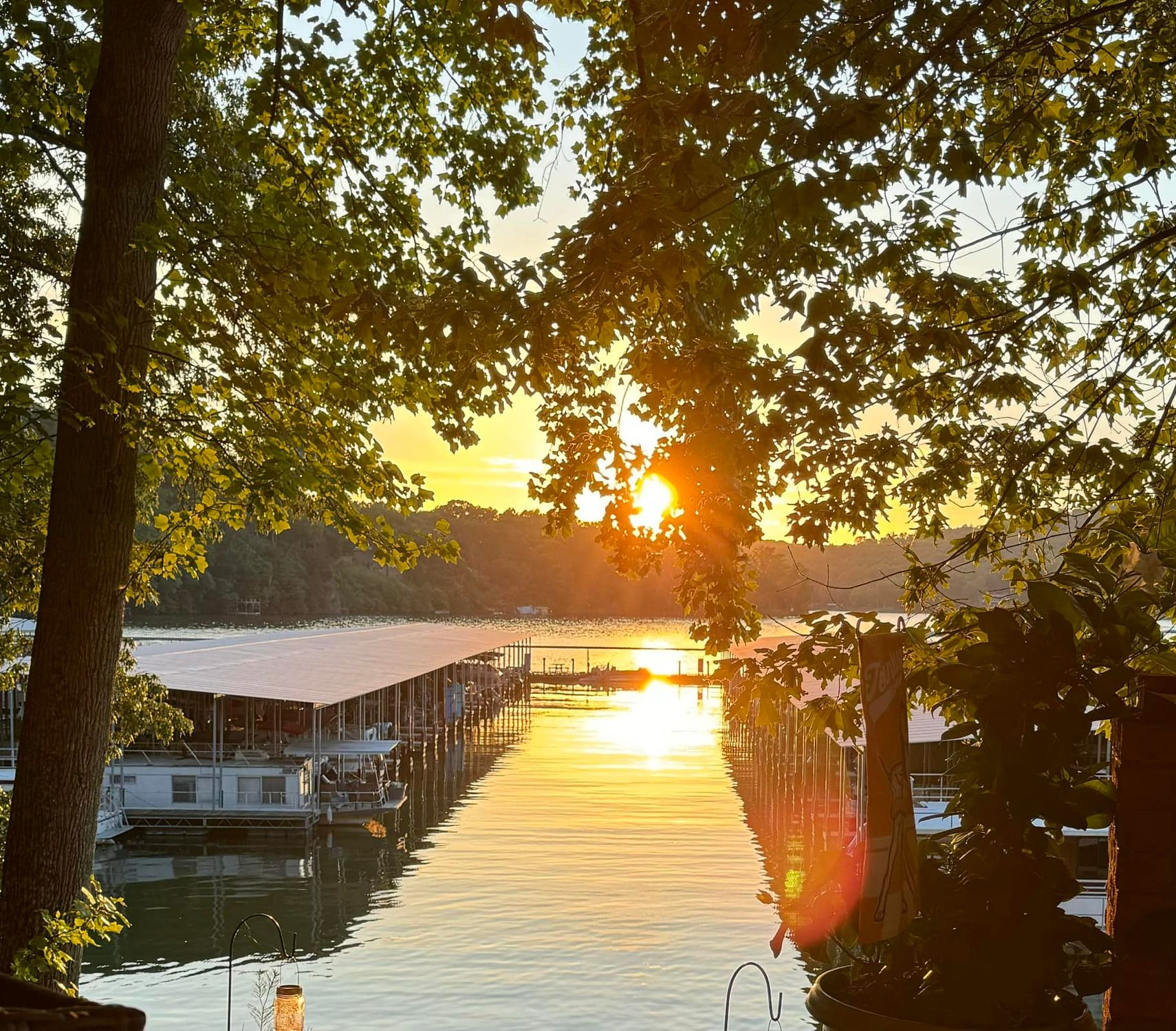 About Rockingham Marina Sunset over a marina, with boats and docks framed by leafy trees and golden reflections on the water.