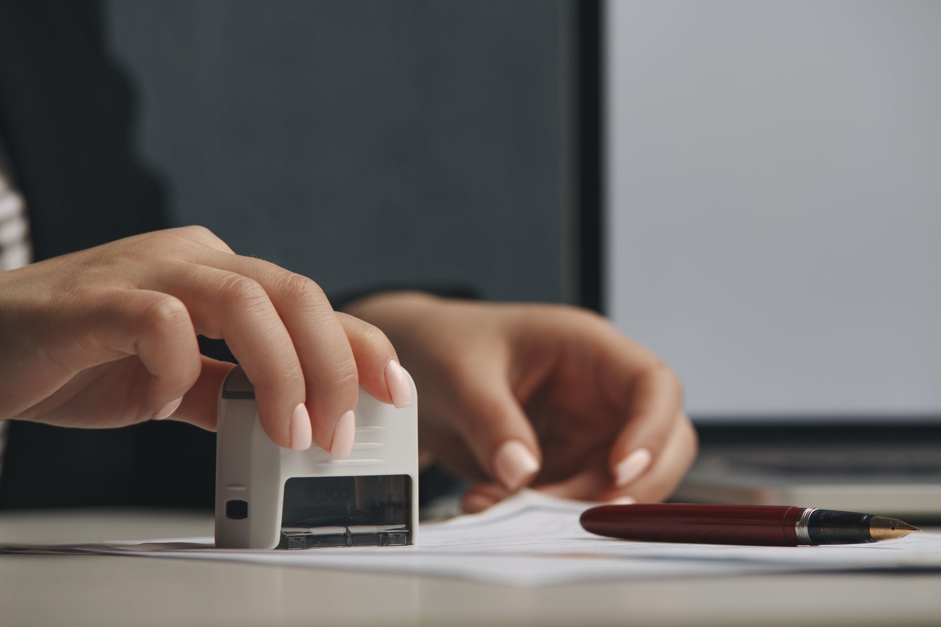 Person calculating taxes, using calculator and looking at documents;