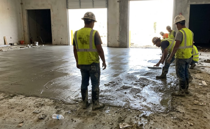 Commercial concrete contractors pouring a strong, reinforced warehouse foundation.