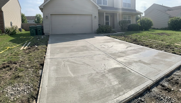 Freshly installed smooth concrete driveway in front of a Pasco WA home