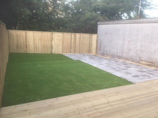 Fencing with grass lawn and concrete wall