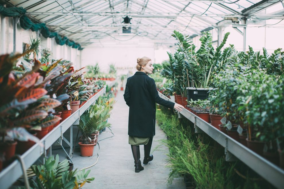Woman walking through a garden centre