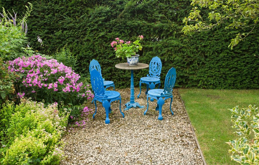 Small garden patio area with furniture and gravel path