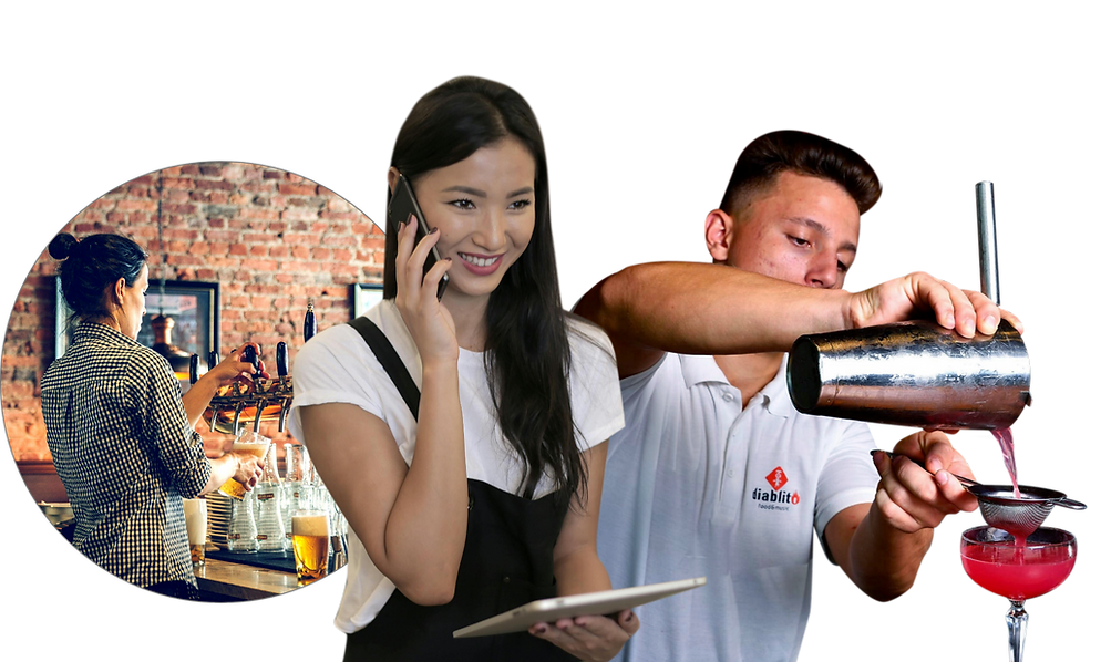 A man is pouring a drink into a glass while a woman talks on a cell phone.