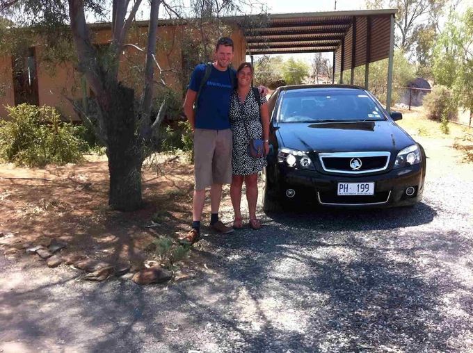 A Man And Woman Standing In Front Of A Black Car — A & P Private Hire In Sadadeen, NT