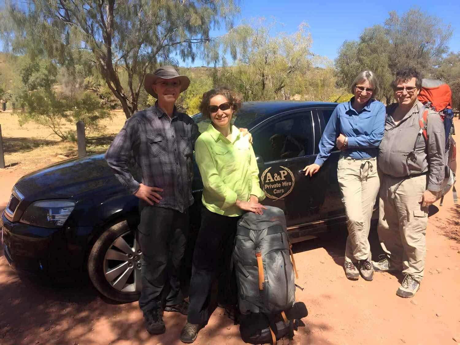 A Group Of People Are Posing For A Picture In Front Of A Car โ A & P Private Hire In Sadadeen, NT