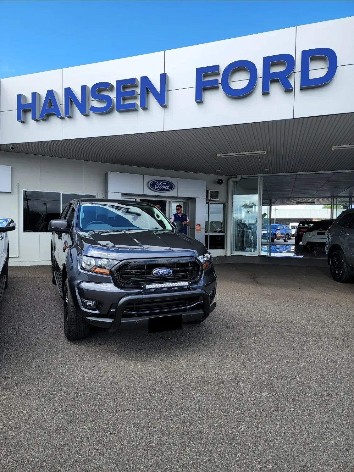 A Ford Truck is Parked in Front of a Hansen Ford Dealership — Ace Tinting in Mareeba, QLD