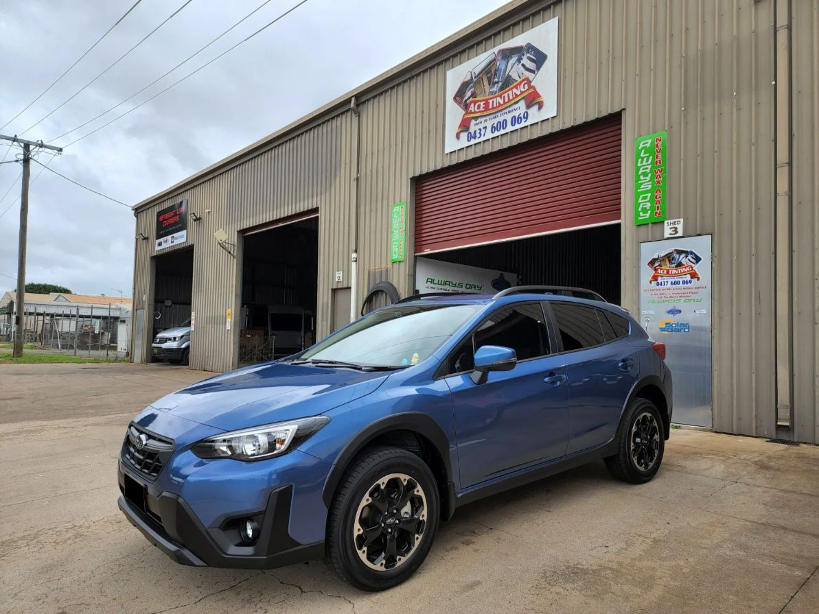 A Blue Subaru XV is Parked in Front of a Garage — Ace Tinting in Mareeba, QLD