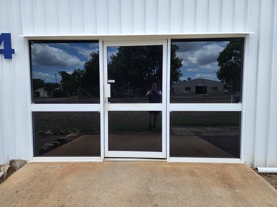 A White Building With a Tinted Door — Ace Tinting in Mareeba, QLD