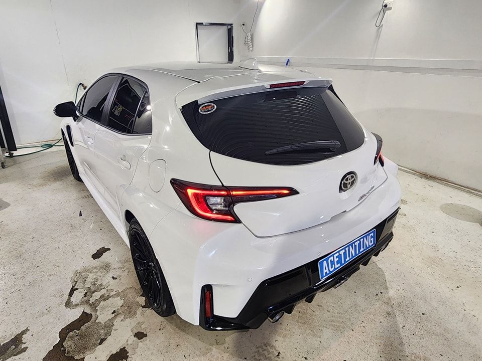 A White Toyota Corolla Hatchback is Parked in a Garage — Ace Tinting in Mareeba, QLD