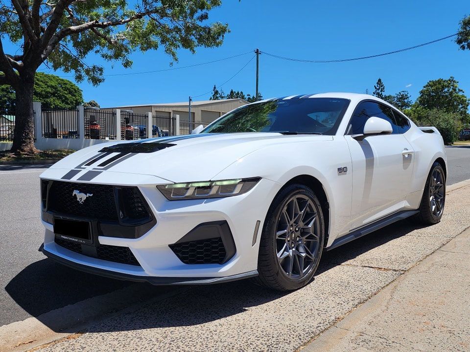 A white ford mustang is parked on the side of the road — Ace Tinting in Mareeba, QLD