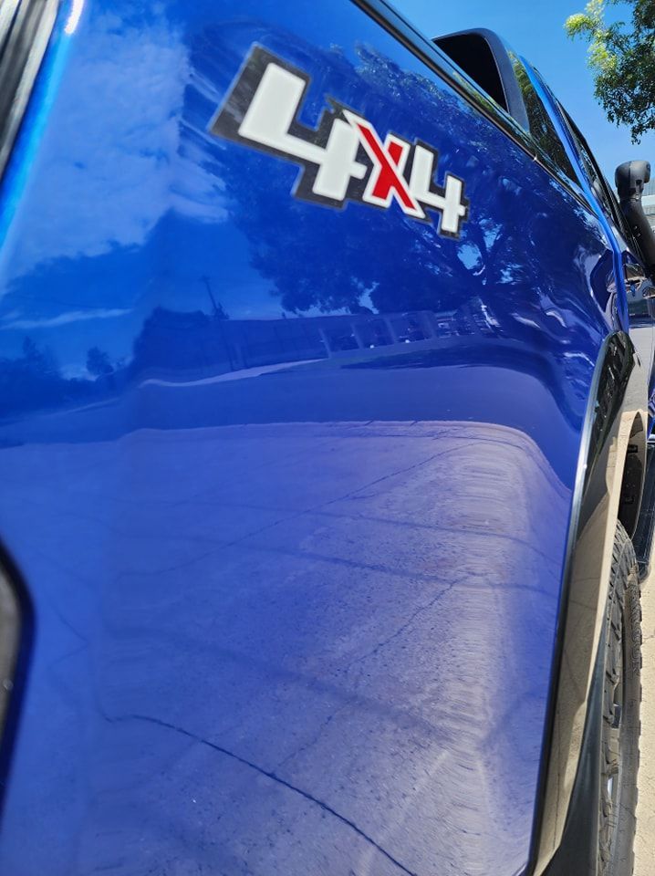 A blue 4x4 truck is parked on the side of the road — Ace Tinting in Mareeba, QLD
