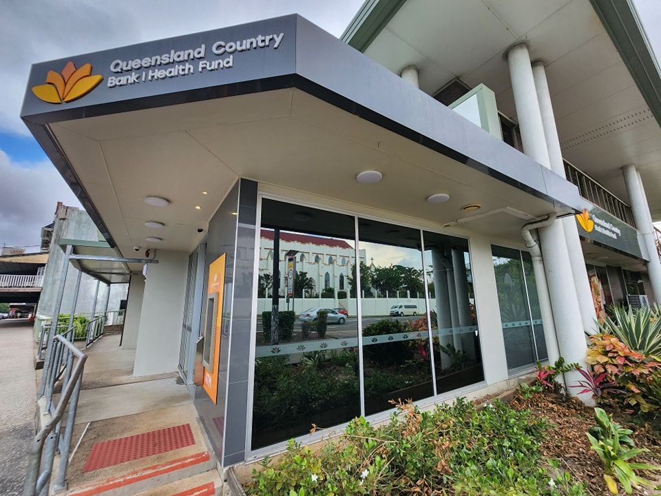 The front of a building with a sign that says queensland country health fund — Ace Tinting in Mareeba, QLD