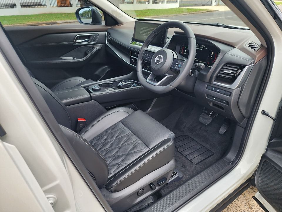 The interior of a white nissan rogue with the door open — Ace Tinting in Mareeba, QLD