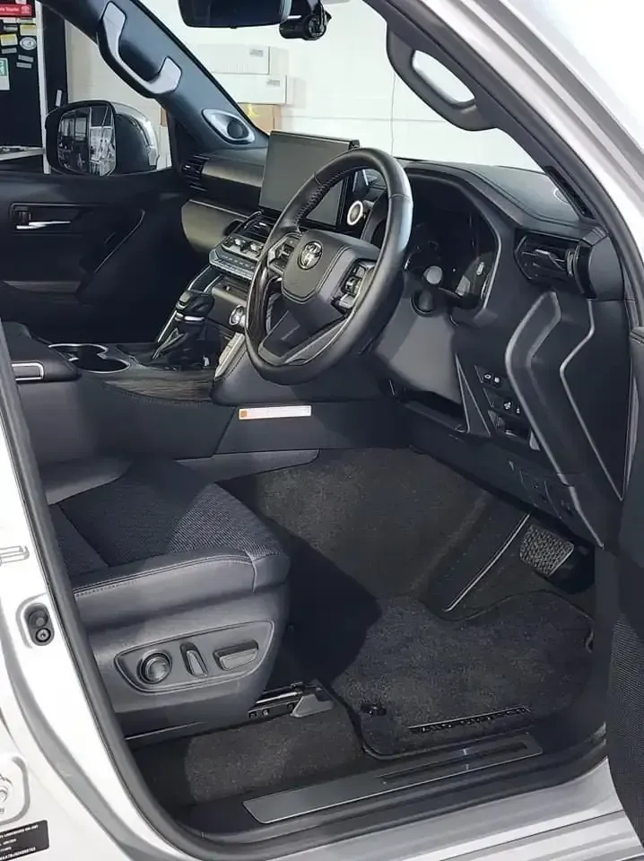 The Interior of a White Car With the Door Open and the Steering Wheel Visible — Ace Tinting in Mareeba, QLD