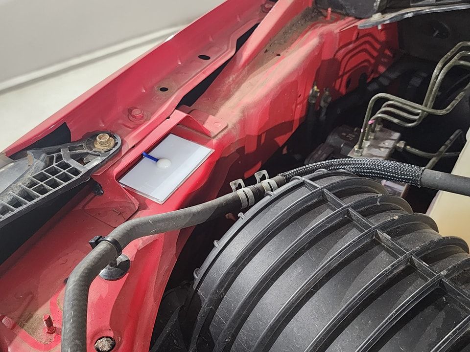 A close up of the engine of a red car — Ace Tinting in Mareeba, QLD