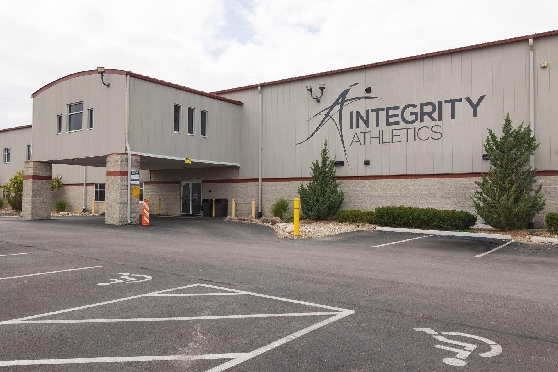 Integrity Athletics building exterior with parking lot and gray facade