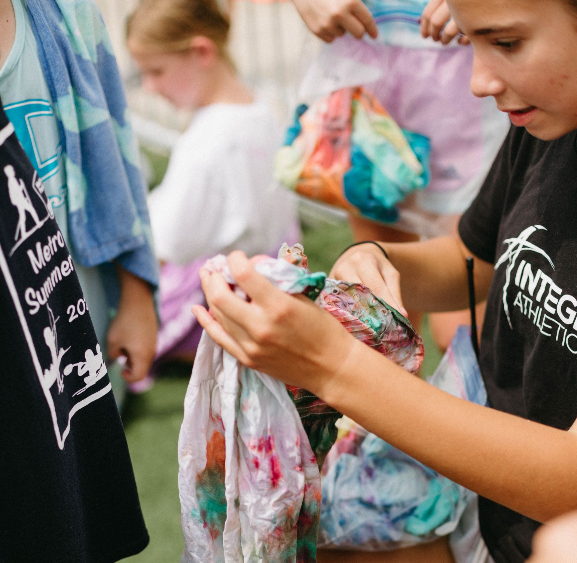 Children making shirts outside