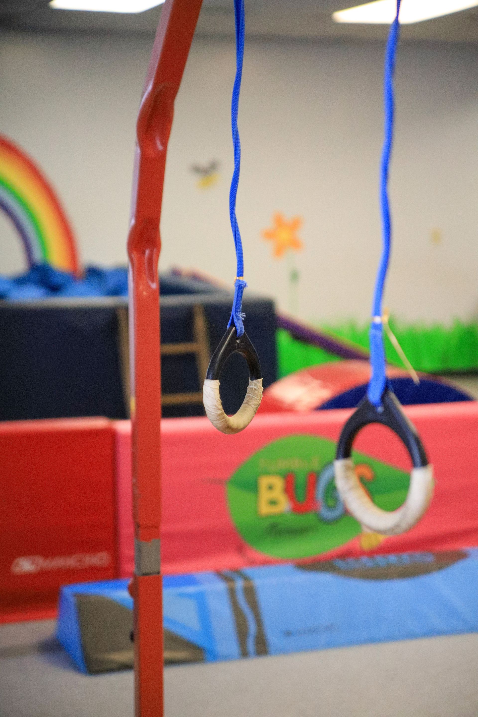 Children’s playground with hanging gym rings and colorful play equipment