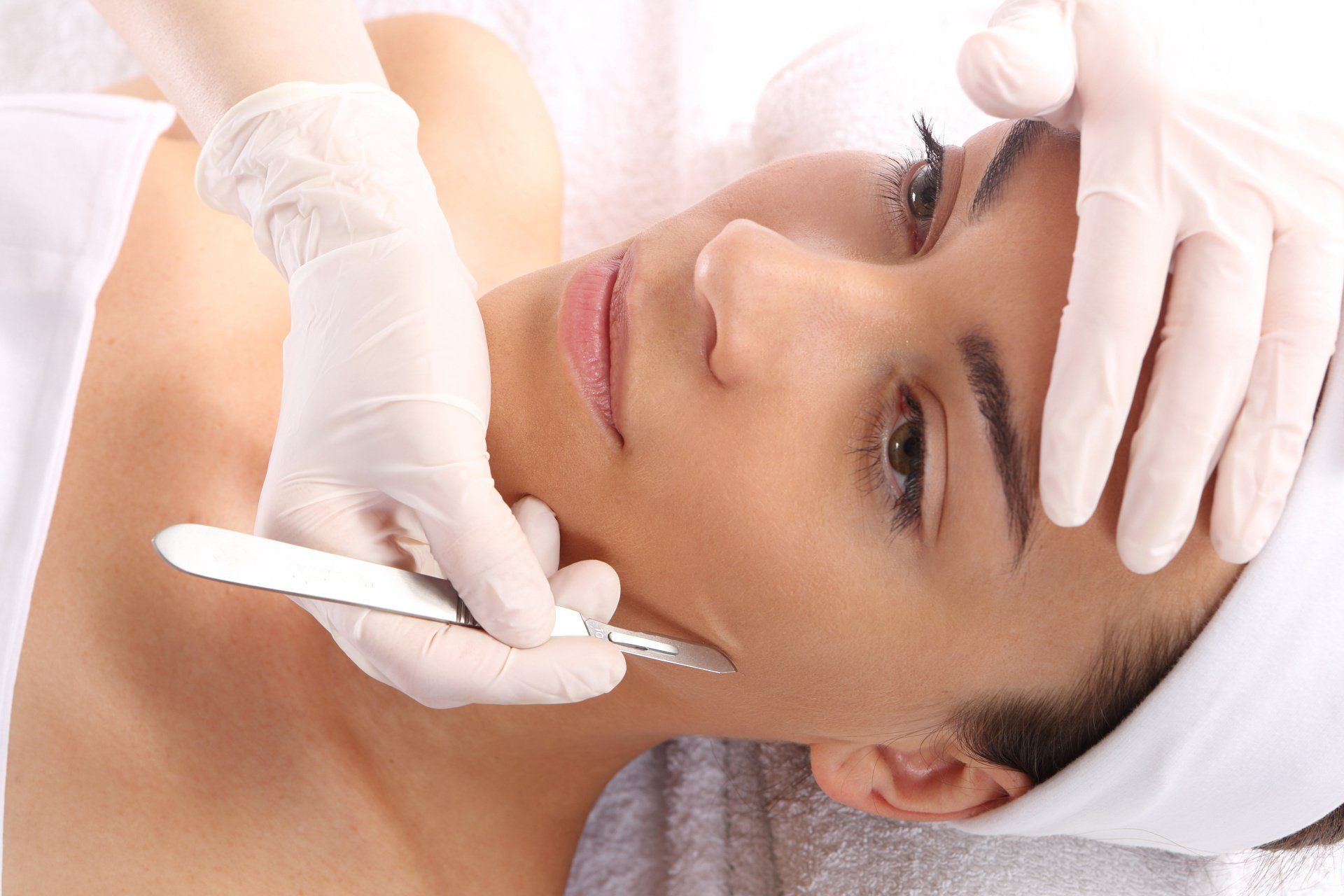 A woman is getting a facial treatment at a spa.