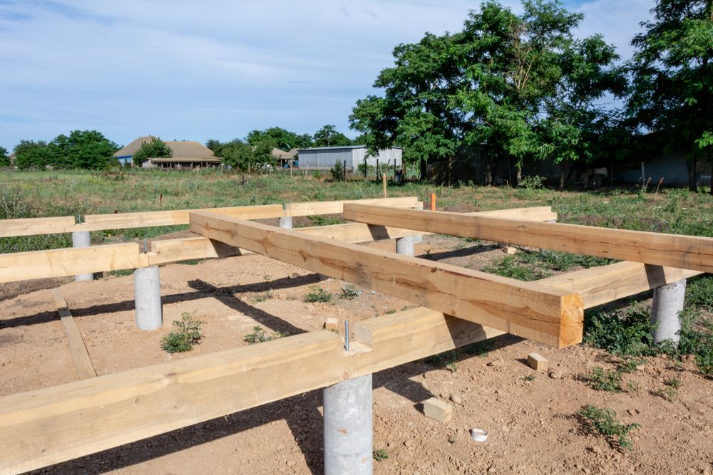 Wooden Foundation Beams on Concrete Piers at a Rural Construction Site — Ground Screws SEQ Pty Ltd In Meridan Plains, QLD
