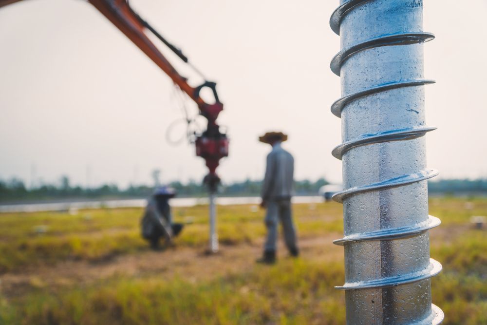 Construction Workers With a Red Drilling Rig on a Field, Seen Past — Ground Screws SEQ Pty Ltd In Meridan Plains, QLD