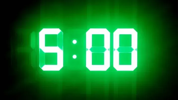 Green digital display reading “5:00” on a black background