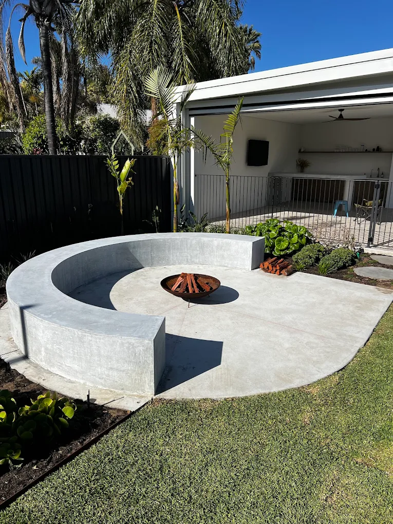 Architectural concrete firepti and bench seat with clean edges.
