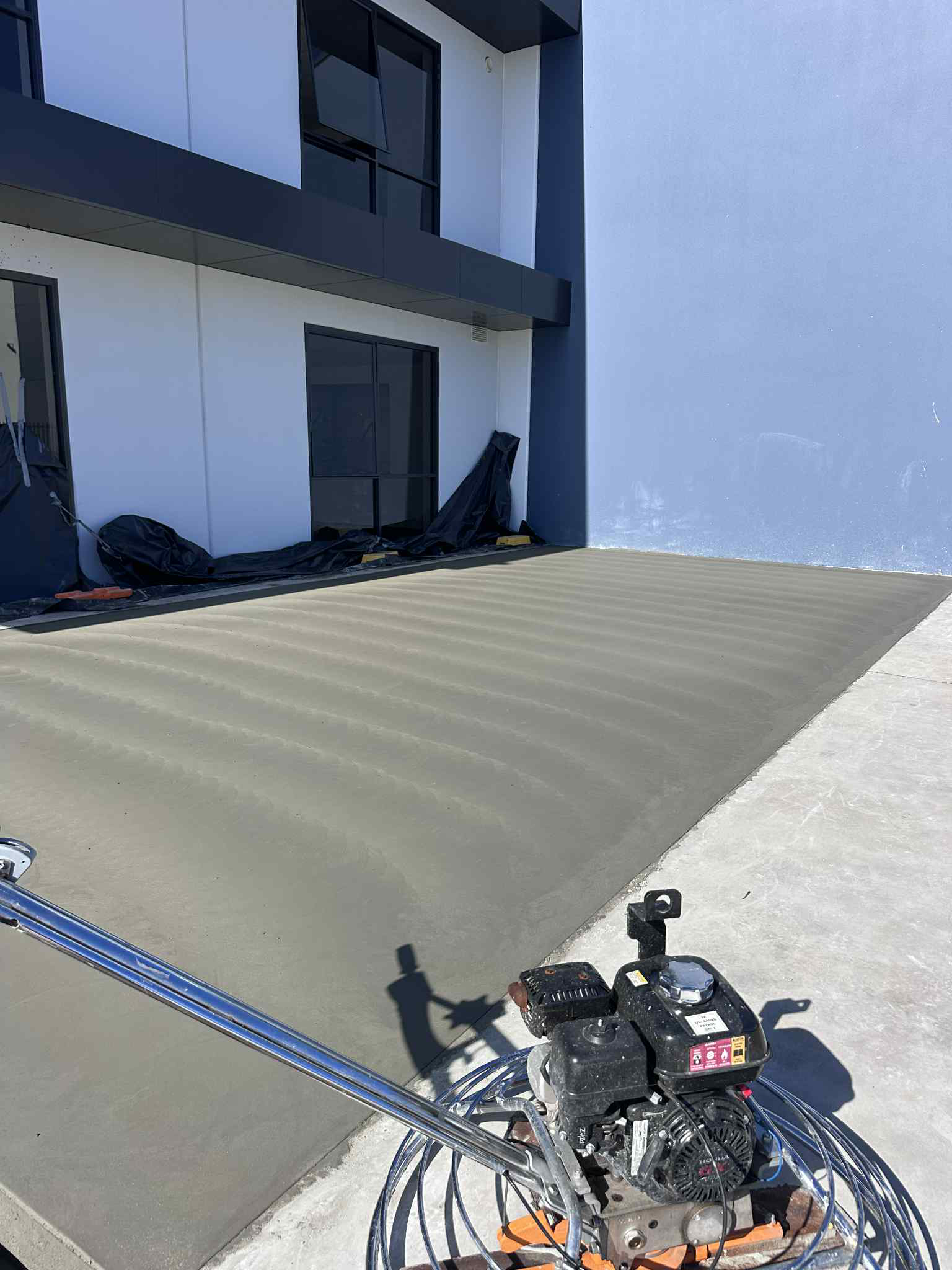 New concrete slab with concrete trowel machine and commercial unit