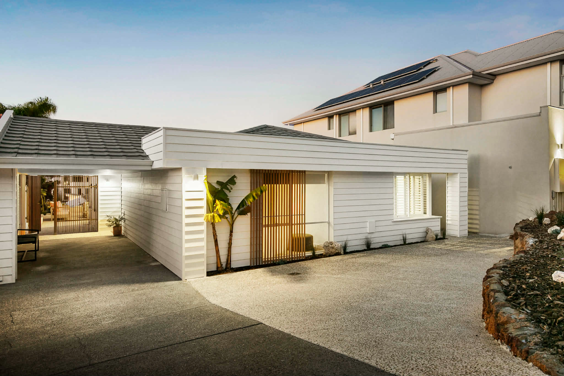 Wattle White exposed aggregate driveway and front walkway at a North Beach home, in a coastal style by Woodlands Construct.