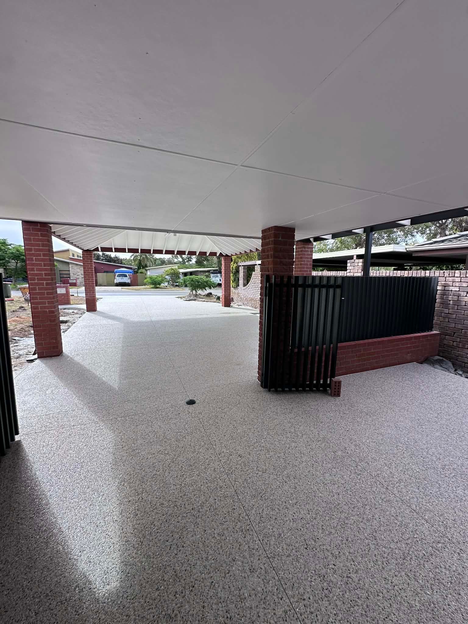 Eucalyptus and white exposed aggregate driveway and patio area