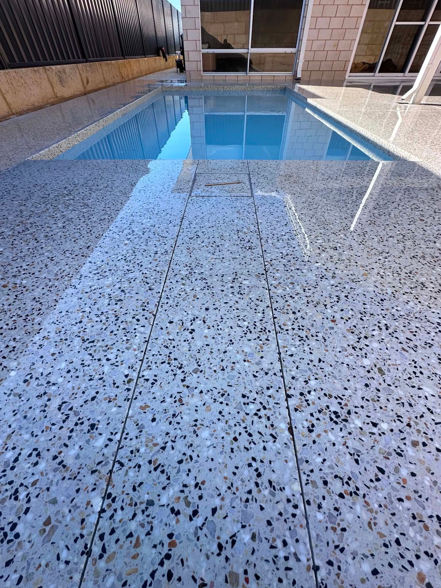 Honed concrete pool surrounds in Perth backyard.