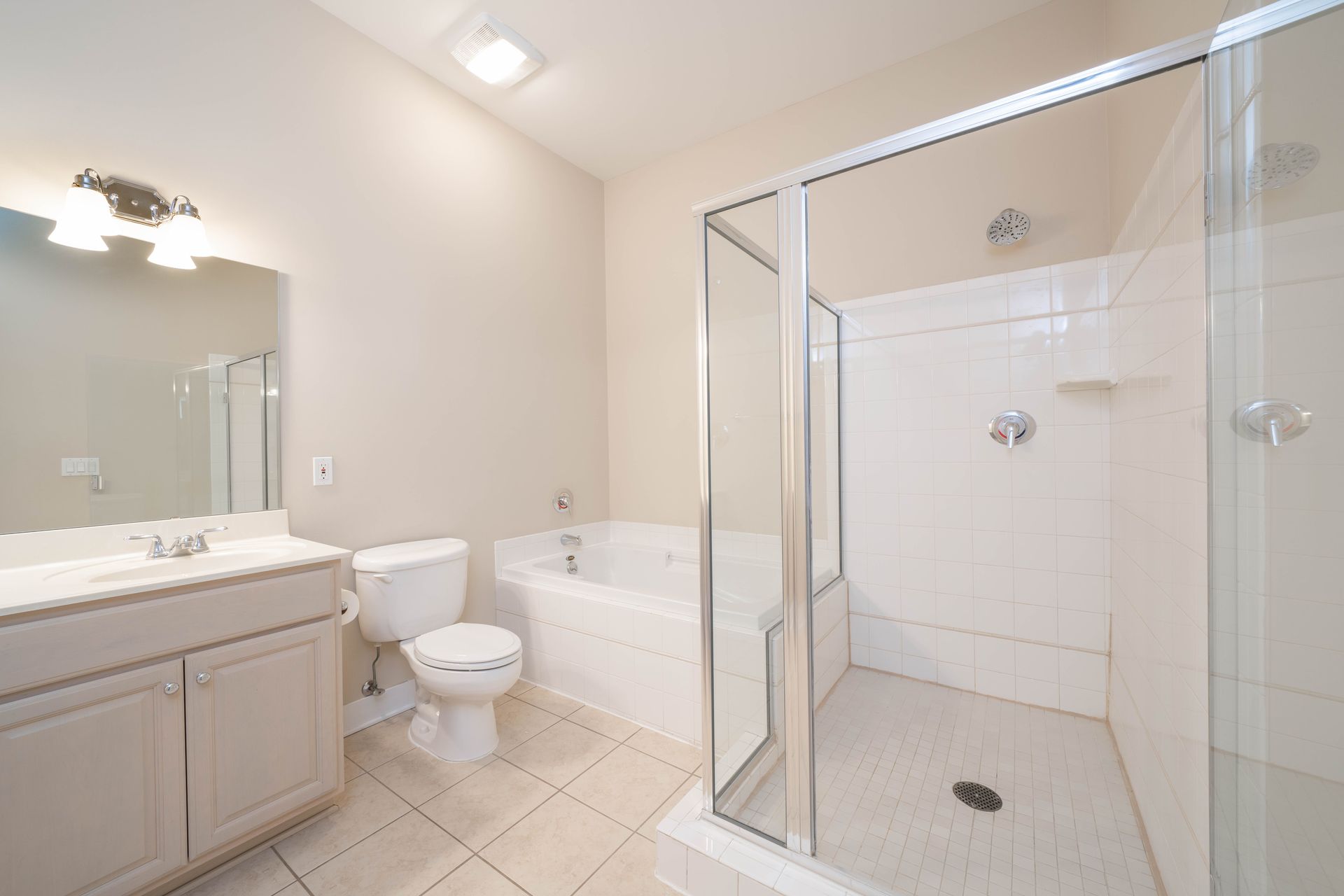 A bathroom with a toilet , sink , tub and shower.