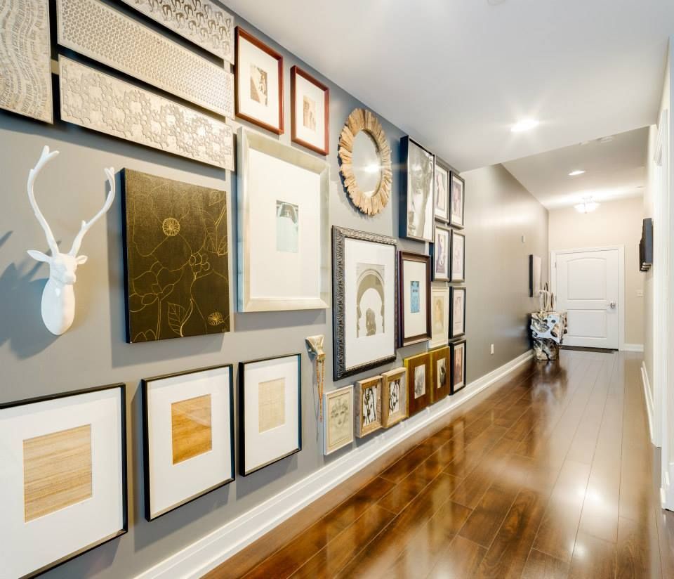 A hallway filled with pictures and a deer head
