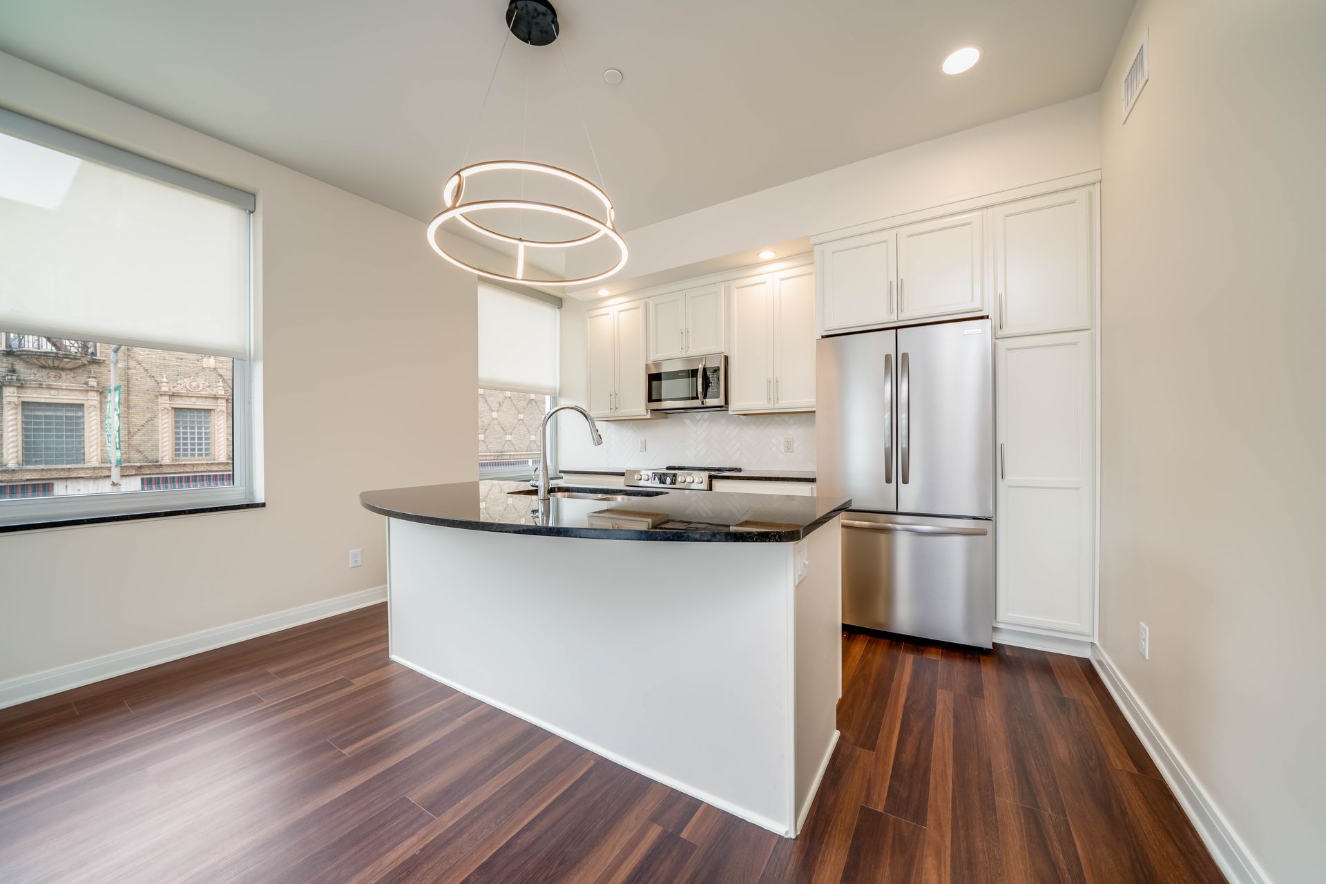 A kitchen with stainless steel appliances and a large island.