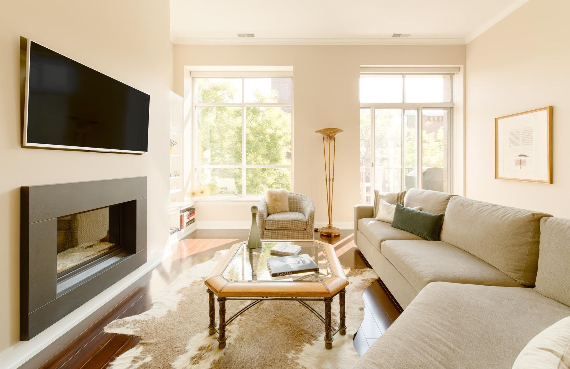 A living room with a fireplace and a flat screen tv